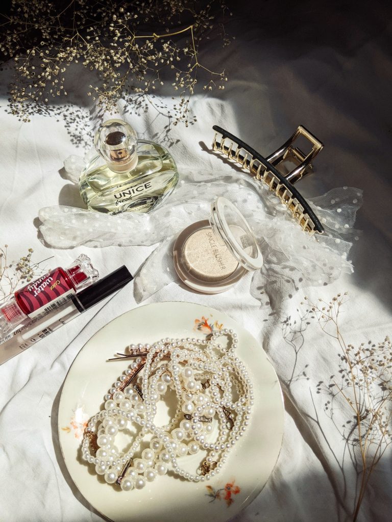Fashion accessories and jewelry items on light background